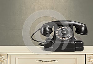 Retro black telephone on background