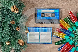 Retro blue audio cassette and christmas decorations on bown wooden background.