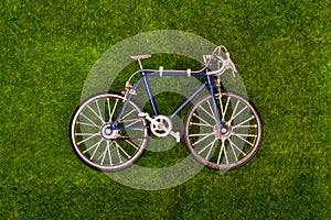 retro blue toy bike on the grass meadow