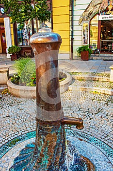 Retro borehole pump on a sunny day, old manual water pump (lever pump). Monument in Slovakia in the city of Nitra