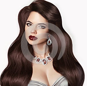 Retro Brunette woman with long shiny wavy hair. Beauty makeup. H