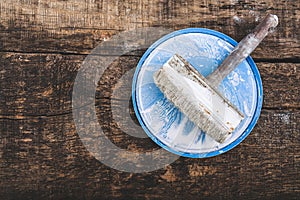 Retro brush for whitewashing walls on a wooden oak board, toning, copyspace