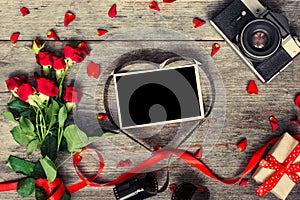 Retro camera and blank photo frame in heart shaped film