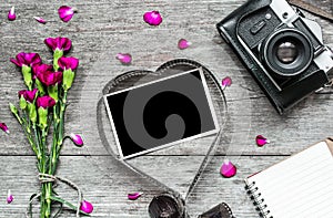 Retro camera and blank photo frame in heart shaped film