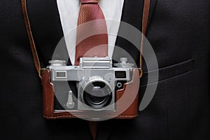 Retro camera with business suit background. Retro background.