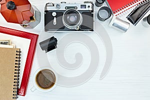 Retro camera, coffee pot, red photo frame and notebook on white