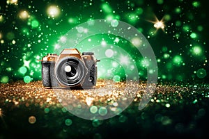 Retro camera on glitter background with bokeh lights and stars