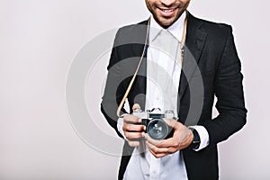 Retro camera in hands of handsome guy in suit. Leisure, travelling, journalist, photograph, hobbies, smiling, having fun