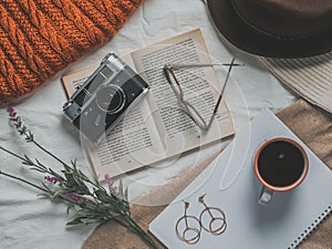 Retro camera, notepad, cup of coffee, hat, glasses, book and flowers on a white background. Romantic style