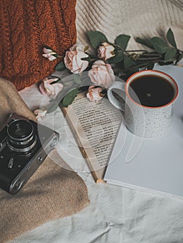 Retro camera, notepad, cup of coffee, hat, glasses, book and flowers on a white background. Romantic style