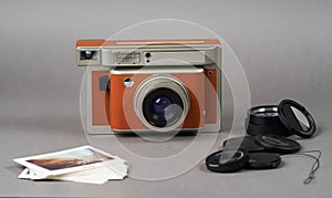 Retro camera and old photo film rolls on gray background