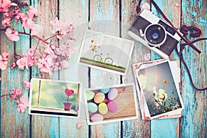 Retro camera and paper photo album on wood table with flowers border design