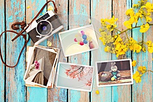 Retro camera and paper photo album on wood table with flowers border design