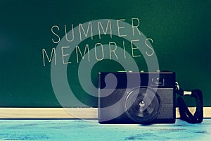 Retro camera and the text summer memories, filtered photo