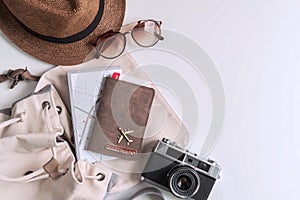 Retro camera with travel accessories and items on white background with copy space