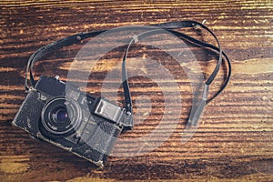 Retro camera on vintage wooden board