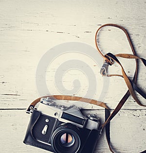 Retro camera on white wooden table