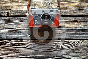 Retro camera on wood table background, vintage color tone