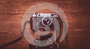 Retro camera on wood table background vintage color tone