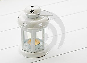 Retro candle lantern lamp at white wood panel