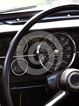 Retro car dashboard interior. View of the steering wheel and dashboard of an old vintag car photo