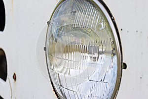 Retro car round headlamp close up view