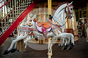 Retro carousel white, black horse. Old wooden horse carousel.