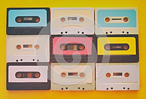 Retro cassette tape collection over yellow wooden table. top view. copy space