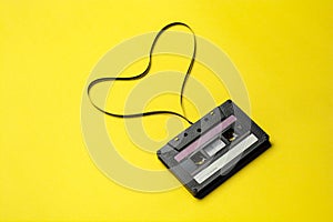 Retro cassette tape over yellow background. top view. copy space