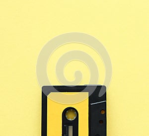 Retro cassette tape over yellow background. top view. copy space.