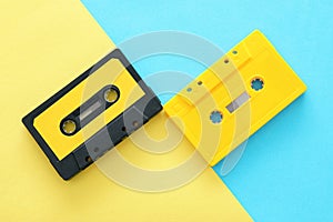 Retro cassette tape over yellow and blue double colorful background. top view. copy space.