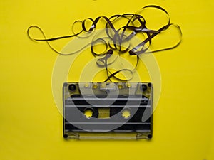 Retro cassette tape over yellow wooden table. top view. copy space