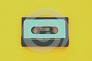 Retro cassette tape over yellow wooden table. top view. copy space