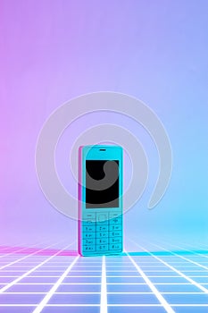 Retro cell phone vintage concept. White old mobile telephone in neon pink blue light. Retro wave. Pop art. minimal idea
