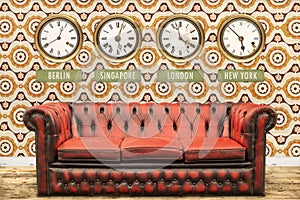 Retro chesterfield sofa with world time clocks on a wall