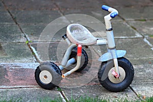 Retro child tricycle bike on the pavement