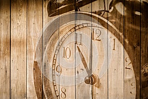 retro clock on wood background selective focus at number 11 o`clock