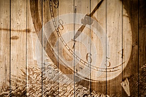 Retro clock on wood background selective focus at number 7 o`clock