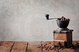 Retro coffee grinder on wooden table