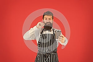 Retro coffee house. mature man red background. skilled servant. barista hipster chef apron. elegant confident bartender