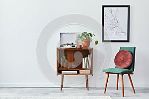 Retro composition of living room interior with mock up poster map, wooden shelf, book, armchair, plant, cacti, vinyl recorder.