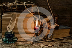 Retro  composition with old documents, books, burning candle and and  inkwell. Space for text