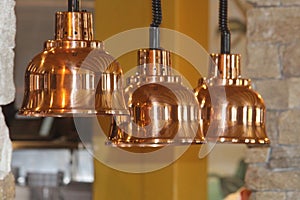 Retro copper lighting decor over a servery photo