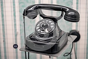 Retro corded rotary telephone in an old room.