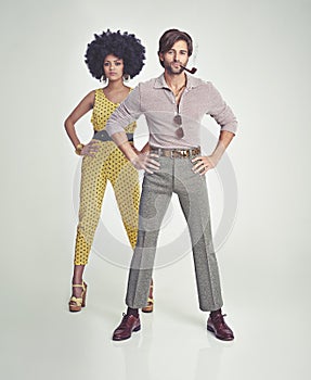 Retro couple. An attractive young couple standing together in retro 70s clothing.