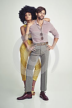 Retro couple. An attractive young couple standing together in retro 70s clothing.