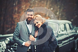 Retro couple at vintage car travelling in winter