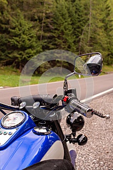 Retro cruiser motorcycle parked at side of mountain road in South tyrol; nostalgic look of the indian classic style