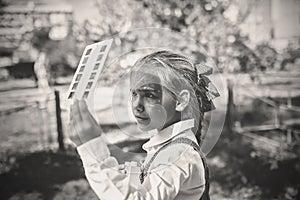 Retro device, soviet stereoscope. Cute girl watching 3D pictures with vintage slide viewer