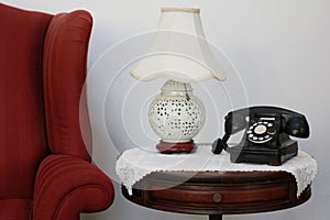 Retro dial phone, decorative lamp on round chair side table